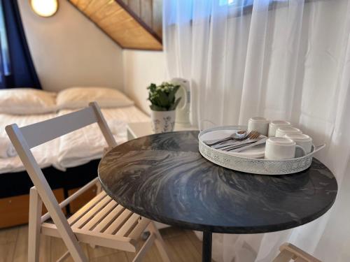 a table and a chair and a bed in a room at Dom Wypoczynkowy Morski Oddech in Łeba