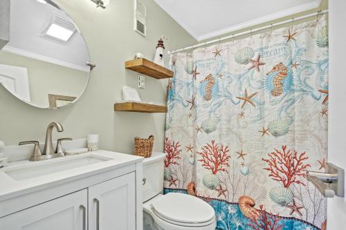 a bathroom with a sink and a shower curtain at Ocean Pier #122 in Myrtle Beach