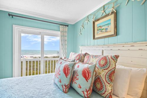 a bedroom with a bed with a view of the ocean at Ocean Pier #122 in Myrtle Beach