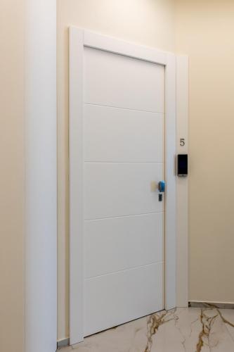 a white door in a room with a marble floor at Bologna Centrale 1 in Bologna