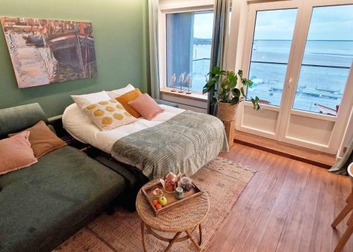 a living room with a bed and a couch at Descente à la mer in Boulogne-sur-Mer