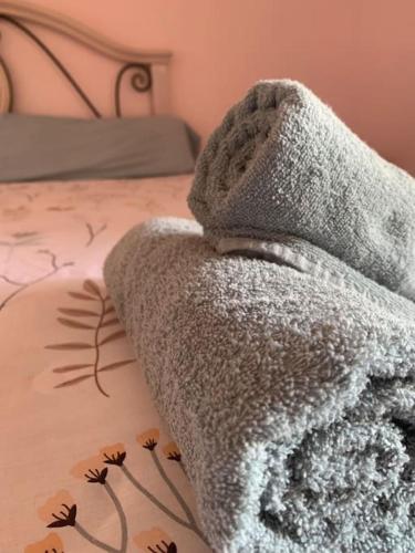a blanket is sitting on top of a bed at Brisa del mar de Valencia in Valencia