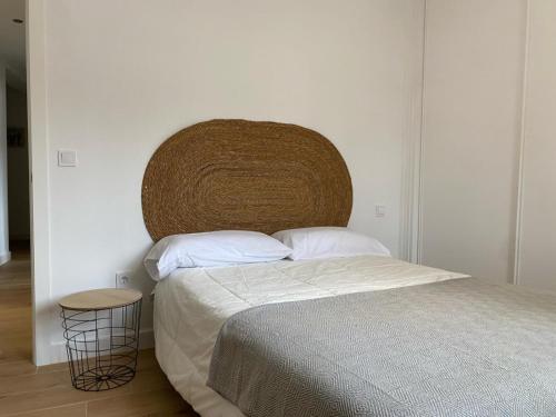 a bedroom with a bed with a large headboard at Reconquista Toledo in Toledo