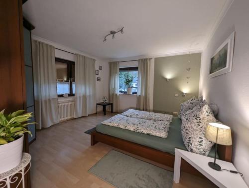 a bedroom with a bed and a living room at Gemütliche Ferienwohnung für 2 in Bad Soden-Salmünster