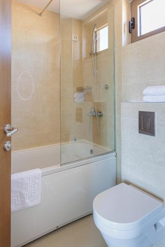 a bathroom with a shower and a toilet and a tub at Hotel Kadmo by Aycon in Budva