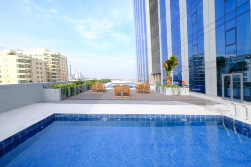 a swimming pool on the roof of a building at Farhan Tower in Juffair