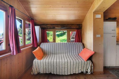 a couch in the corner of a tiny house at Natura e Relax in Sacco