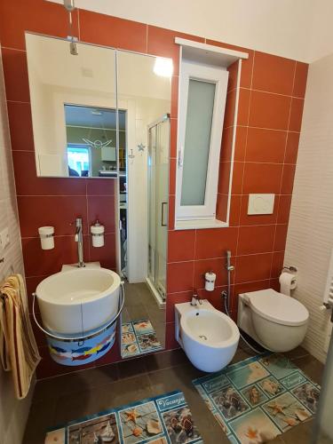 a bathroom with two sinks and a toilet at Dimora Kalypso in Polignano a Mare