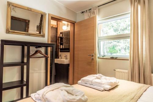 a bedroom with a bed and a sink and a window at Luxury Lakefront villa, infinity hot tub and sauna in Grímsnes og Grafningshreppur