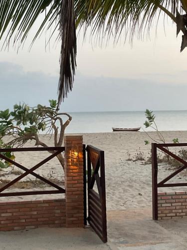 an open door to the beach with the ocean at BEACH HOUSE - Loggia Suite 3 - com cozinha - na praia - BEACHFRONT in Barra Grande