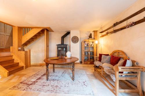 a living room with a table and a wood stove at Chalet Alouette in Champagny-en-Vanoise