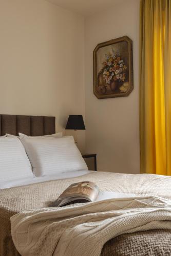 a bedroom with a bed with a book on it at Arte Gdańsk in Gdańsk