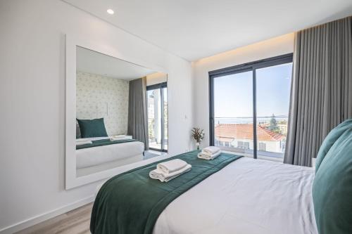 a bedroom with a large bed and a large window at Contemporary Residence B by Homie in Funchal