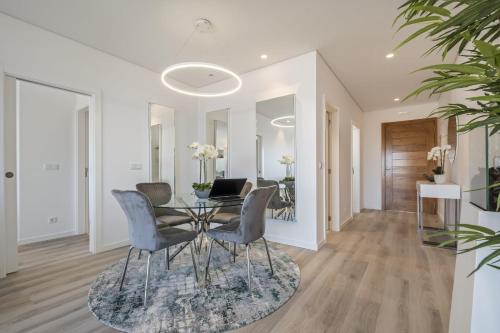a dining room with a table and chairs at Contemporary Residence B by Homie in Funchal