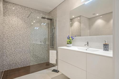 a white bathroom with a sink and a shower at Contemporary Residence C by Homie in Funchal