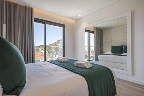 a bedroom with a bed and a large window at Contemporary Residence C by Homie in Funchal