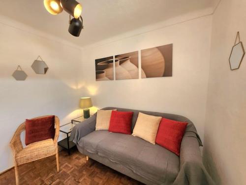 a living room with a gray couch and a chair at Refúgio de Arez-Alojamento Local in Arez