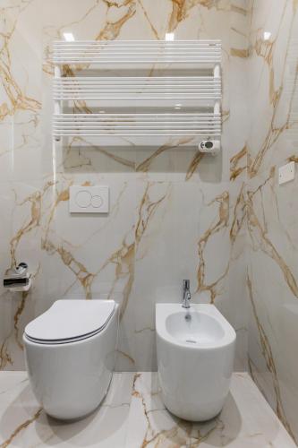 a bathroom with a white toilet and a sink at Bologna Centrale 1 in Bologna