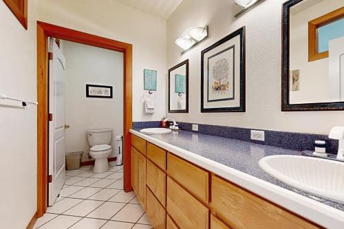 a bathroom with two sinks and a toilet at Anchors Aweigh in Rockaway Beach
