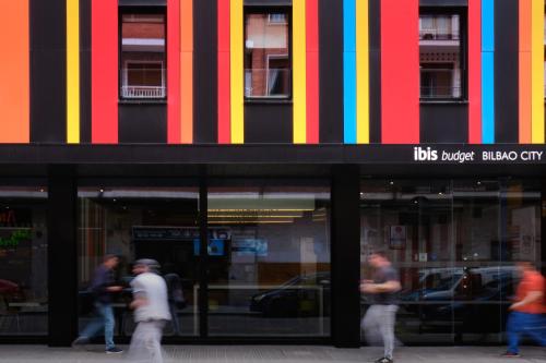 a group of people walking in front of a store at Ibis Budget Bilbao City in Bilbao