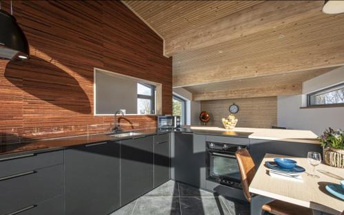 a kitchen with a sink and a table in a room at Au Bailet in Gedinne