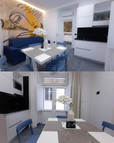 a kitchen and living room with a table and a tv at LA CASA DEGLI DEI PIZZO in Pizzo