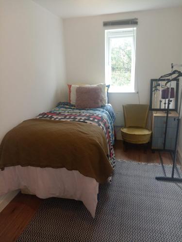 a bedroom with a bed and a window at Cosy room in London