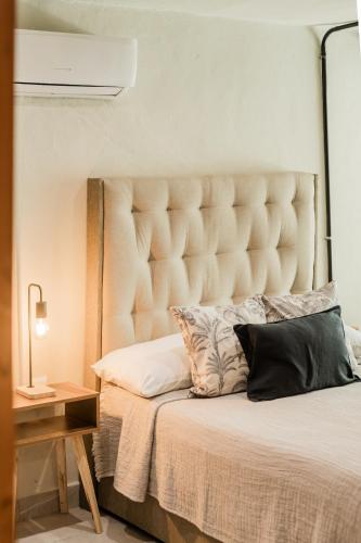 a bedroom with a large bed with a large headboard at CASA ALDAMA- Style & Convenient Apartments in Cancún