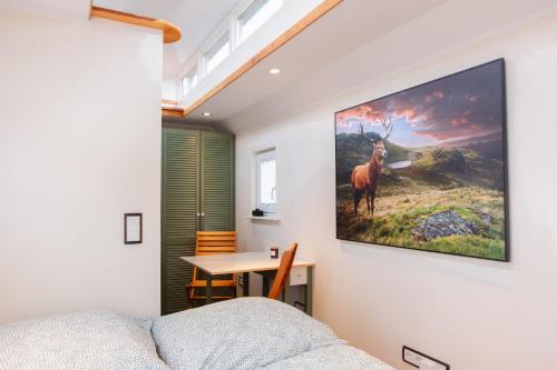 a room with a painting of a deer on the wall at Ilsehof Tiny-House Mimi 