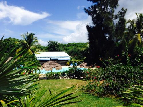 a view of a resort with a swimming pool at Au Village de Menard in Saint-Louis