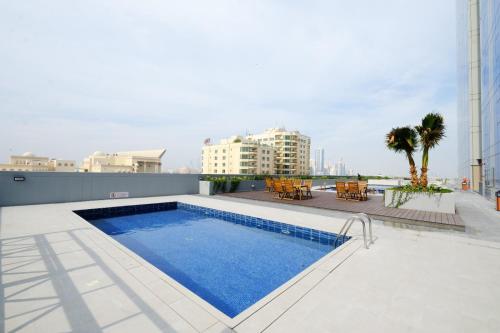 a swimming pool on the roof of a building at Farhan Tower in Juffair
