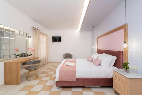 a hotel room with a bed and a desk at Sea View Village in Vasilikos