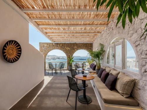 a living room with a couch and a table at Yalos Hotel Sunset view Mykonos town private rooms in Mýkonos City
