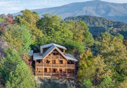 a large wooden house in the middle of a forest at Glimpse of Heaven in Sevierville