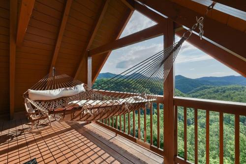 a hammock on a porch with a view of the mountains at Glimpse of Heaven in Sevierville