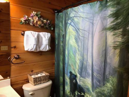 a bathroom with a shower with a painting on the wall at Glimpse of Heaven in Sevierville
