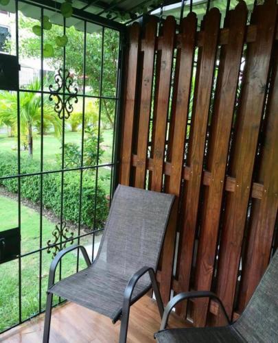 a chair sitting in front of a wooden fence at Aparta air in Pantoja