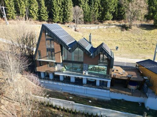 a house with solar panels on top of it at Utopia Lake View in Teşila