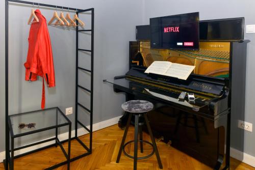 a room with a piano and a ladder and a stool at Walk Inn Váci 78 in Budapest