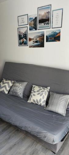 a bed with pillows and pictures on the wall at Le Serre in Belvédère