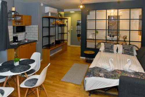 a bedroom with a bed and a table and chairs at Walk Inn Váci 78 in Budapest