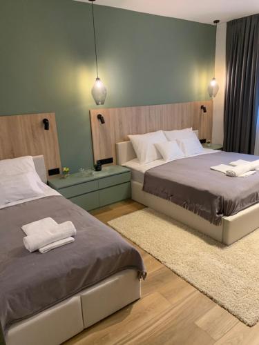 a bedroom with two beds with towels on them at Studio apartment with pool in Budapest