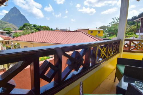 a balcony with a view of a mountain at Apartment Soleil- Because Location really is everything! in Soufrière