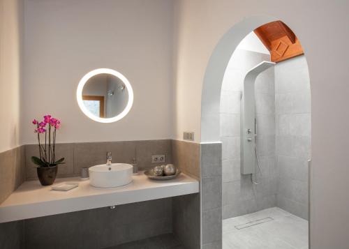 a bathroom with a sink and a shower at Villa Dora Bella in Nazaret