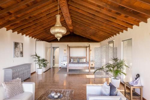 a living room with a wooden ceiling and a couch at Villa Dora Bella in Nazaret