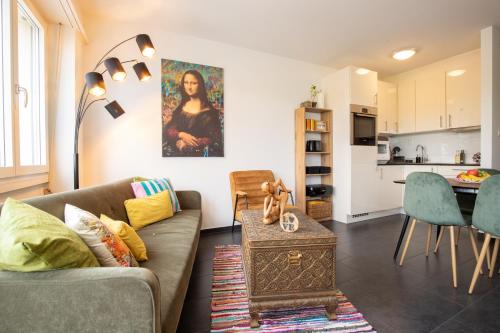 a living room with a couch and a table at Special MODERN LiSA Apartment Basel, Bahnhof Grossbasel 10-STAR in Basel