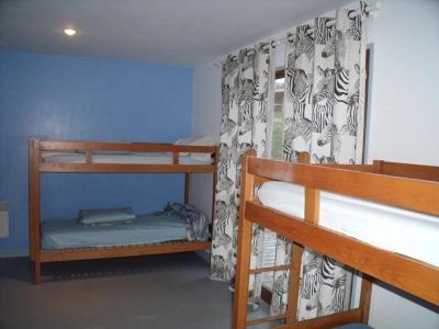 a room with two bunk beds and a curtain at Gite 20 places in Razès