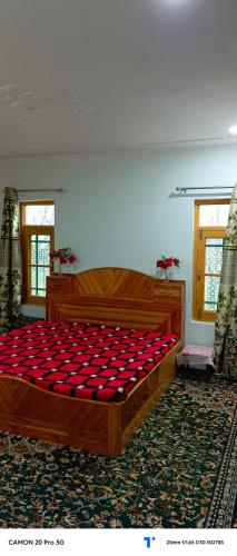 a large bed in a room with a red mattress at The Himalayan Inn homestay in Gulmarg