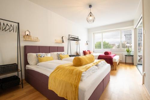a bedroom with two beds and a large window at Special MODERN LiSA Apartment Basel, Bahnhof Grossbasel 10-STAR in Basel