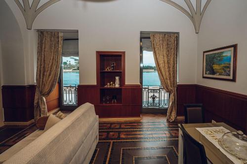a living room with a couch and two windows at Verso Oriente in Brindisi
